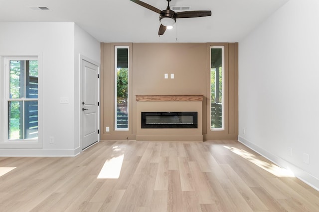 unfurnished living room with ceiling fan and light hardwood / wood-style flooring