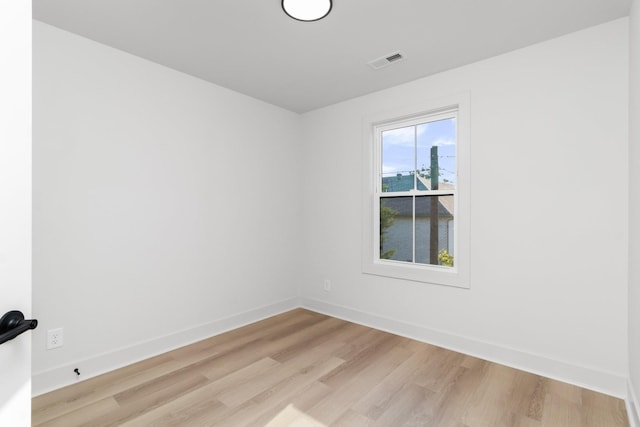 unfurnished room with light wood-type flooring