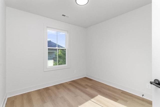 empty room with light hardwood / wood-style flooring