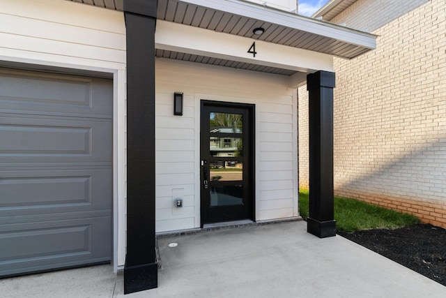 doorway to property with a garage