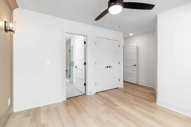 unfurnished bedroom featuring ceiling fan, light wood-type flooring, and a closet