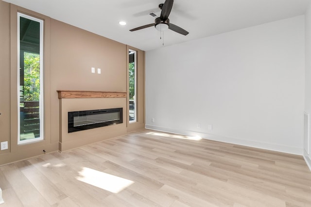 unfurnished living room featuring ceiling fan and light hardwood / wood-style floors