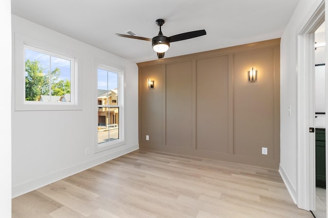 spare room featuring light hardwood / wood-style flooring and ceiling fan