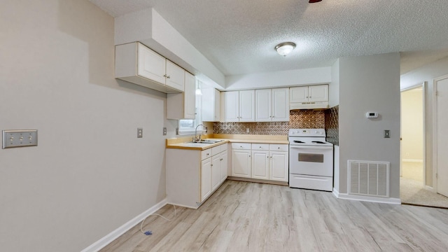 kitchen featuring white cabinetry, sink, tasteful backsplash, light hardwood / wood-style flooring, and white electric stove