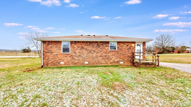 view of side of home with a yard