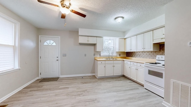 kitchen featuring white range with electric stovetop, ceiling fan, light hardwood / wood-style flooring, white cabinets, and range hood