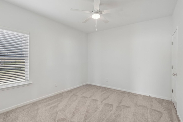 spare room with light carpet and ceiling fan