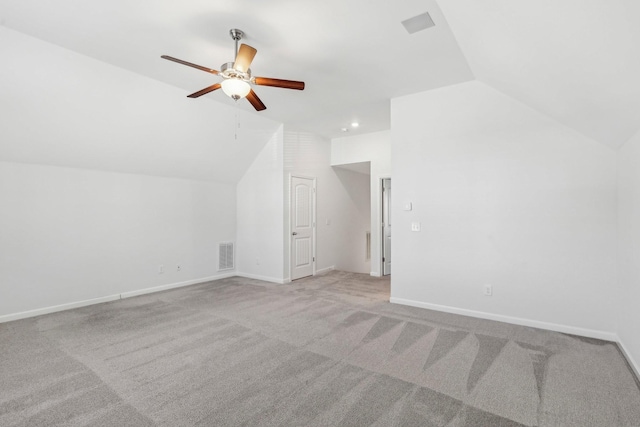 additional living space with ceiling fan, light colored carpet, and lofted ceiling