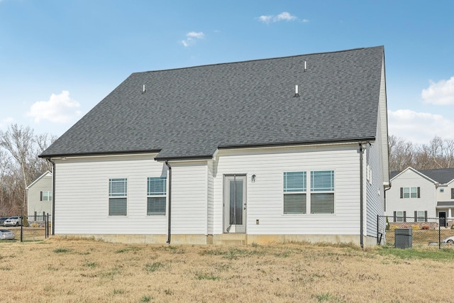 rear view of house with a yard and cooling unit