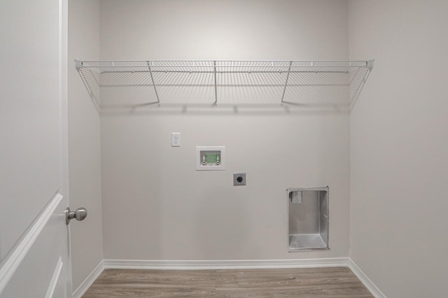 clothes washing area with hookup for an electric dryer, hardwood / wood-style floors, and washer hookup