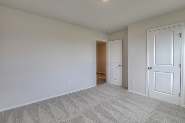 empty room featuring light colored carpet