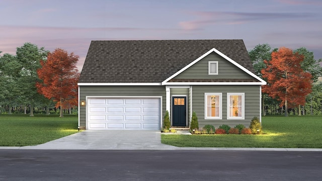 view of front of home featuring a lawn and a garage