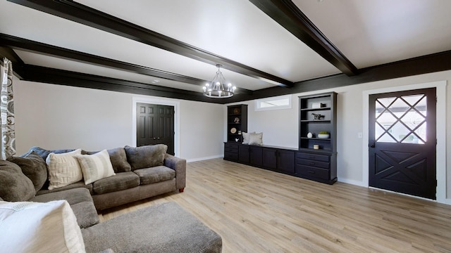 living room with plenty of natural light, light hardwood / wood-style flooring, beam ceiling, and an inviting chandelier