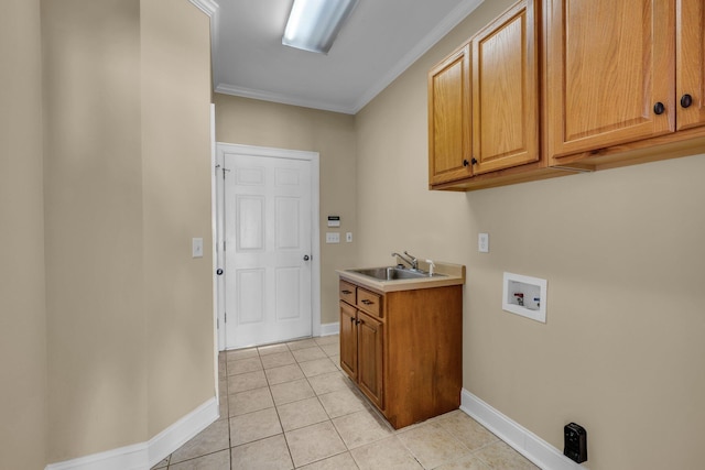 clothes washing area with cabinets, crown molding, sink, hookup for a washing machine, and light tile patterned floors