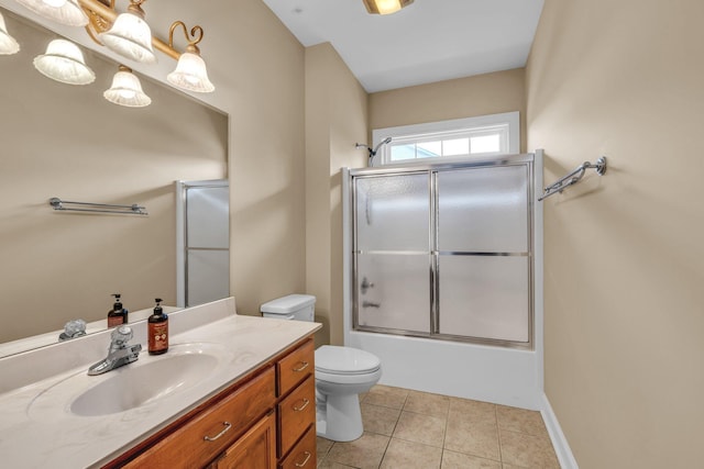 full bathroom featuring tile patterned floors, toilet, vanity, and combined bath / shower with glass door