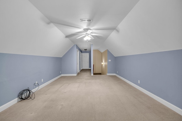 bonus room with light carpet, ceiling fan, and vaulted ceiling