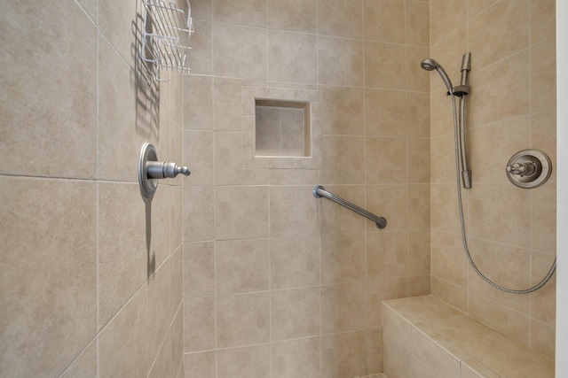 bathroom with a tile shower