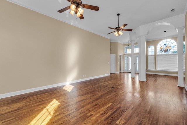 unfurnished living room with decorative columns, crown molding, dark hardwood / wood-style floors, and ceiling fan with notable chandelier