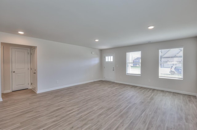 empty room with light hardwood / wood-style flooring