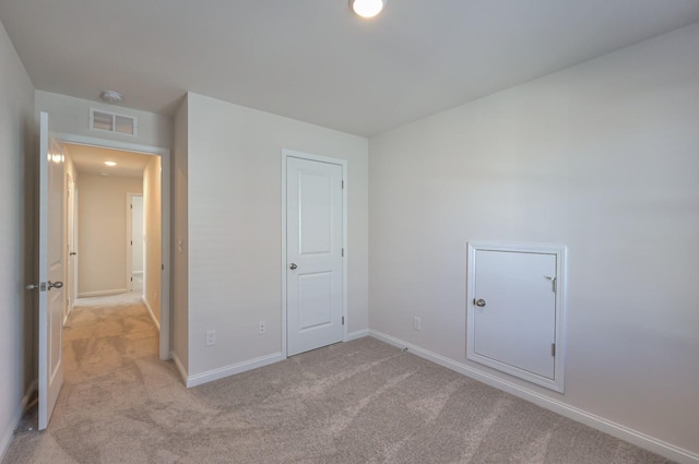 unfurnished bedroom featuring light colored carpet