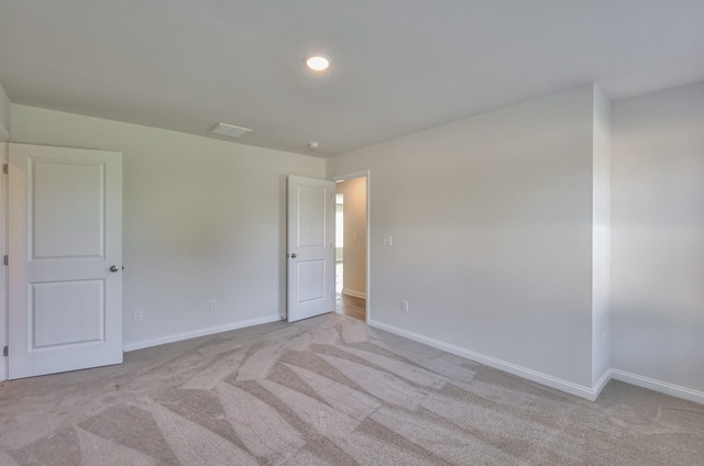 empty room featuring light colored carpet