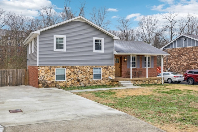 tri-level home with a front lawn and covered porch