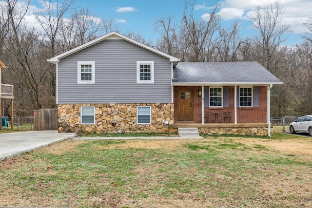 split level home with a front yard and a porch