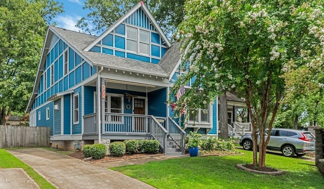 view of front of property with a porch and a front lawn