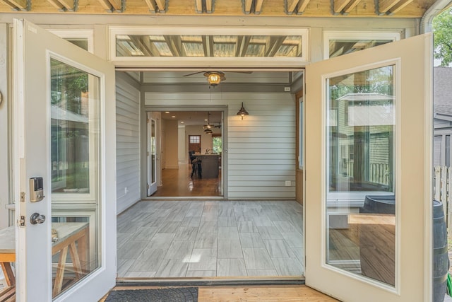 sunroom / solarium with ceiling fan and a healthy amount of sunlight