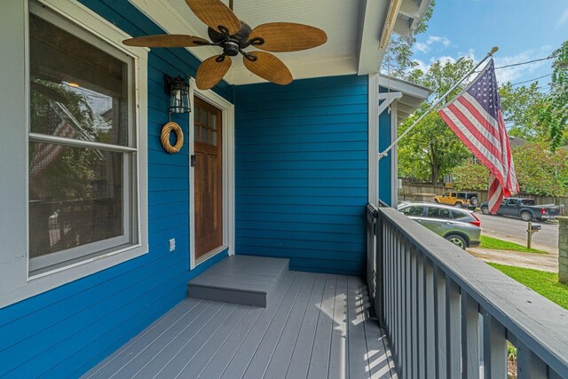 deck with covered porch and ceiling fan