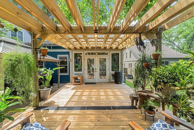 wooden deck featuring a pergola and french doors