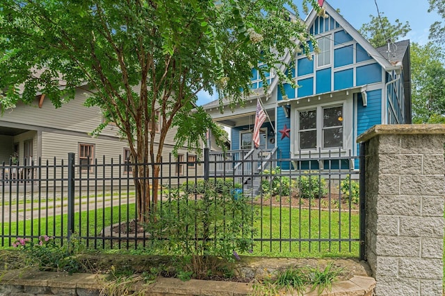 view of front of property with a porch and a front lawn