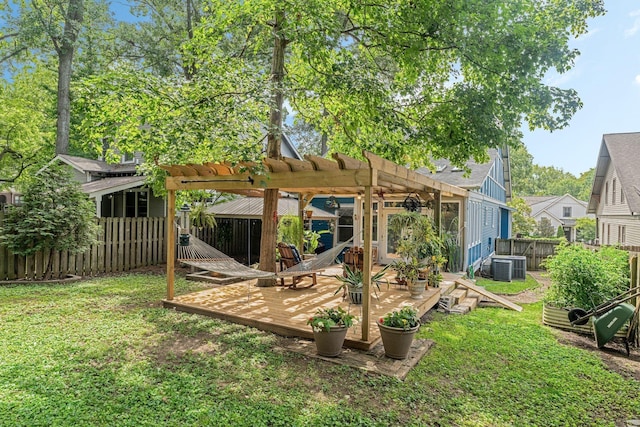 rear view of house with cooling unit, a pergola, a yard, and a wooden deck