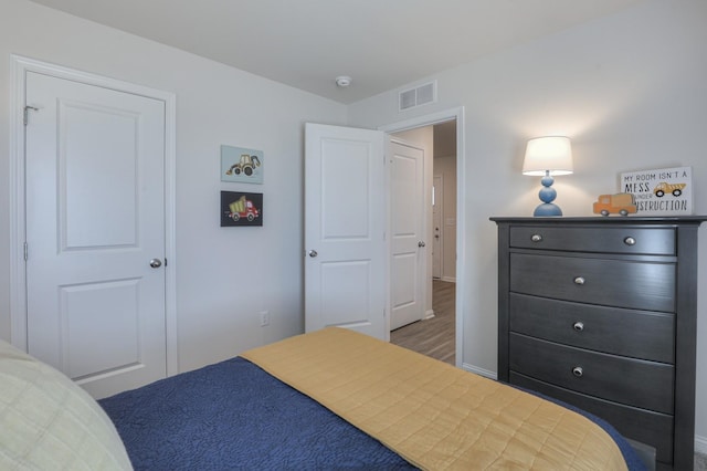 bedroom with dark hardwood / wood-style flooring