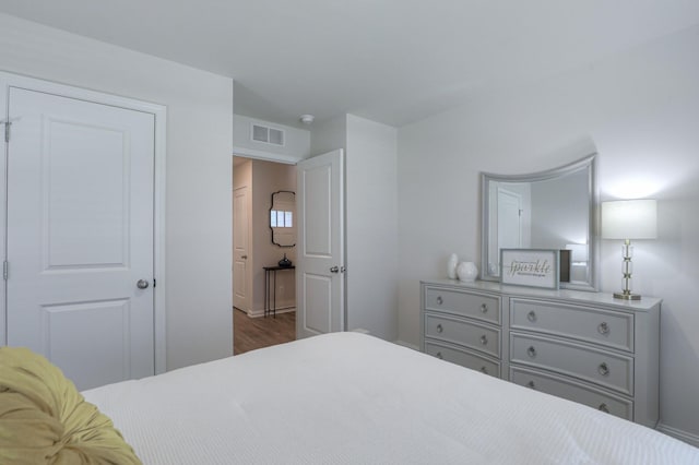 bedroom with hardwood / wood-style flooring