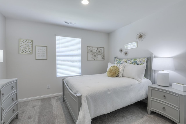 carpeted bedroom featuring multiple windows