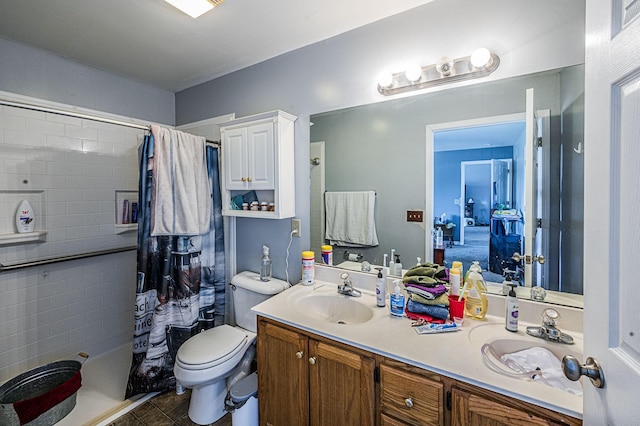 bathroom with vanity, a shower with shower curtain, tile patterned floors, and toilet