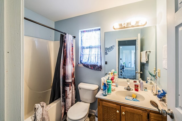 full bathroom with vanity, toilet, and shower / tub combo