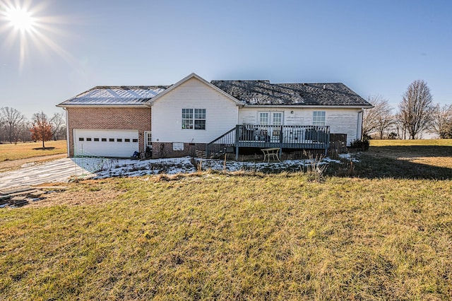 view of front facade with a garage, a front yard, and a deck