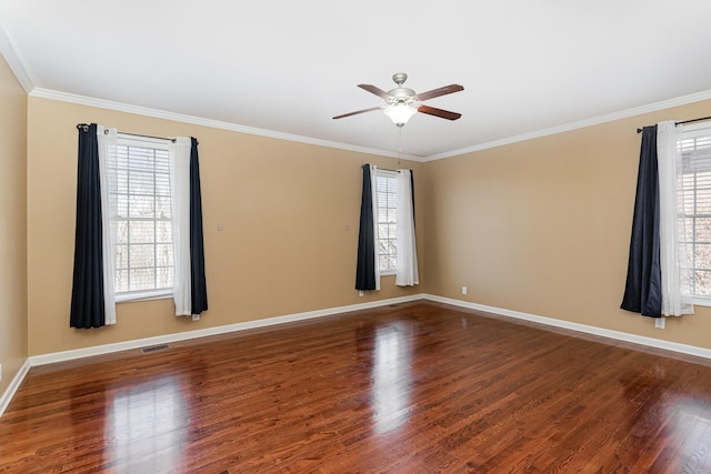 empty room featuring crown molding, dark wood-type flooring, and ceiling fan