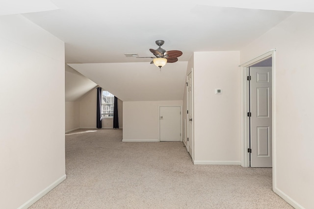 bonus room featuring lofted ceiling, light carpet, and ceiling fan