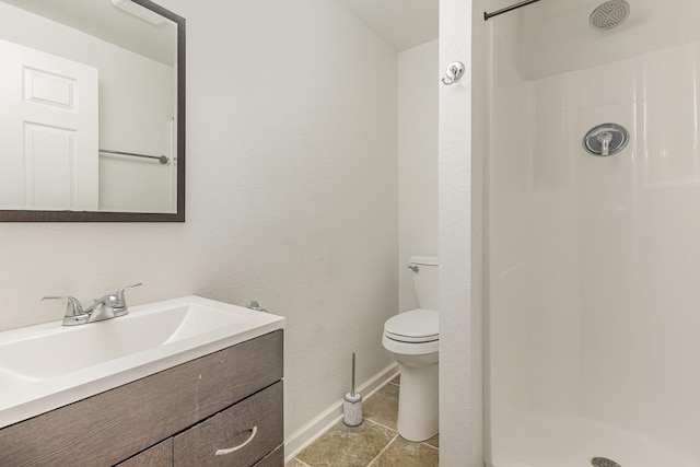 bathroom featuring vanity, toilet, and walk in shower