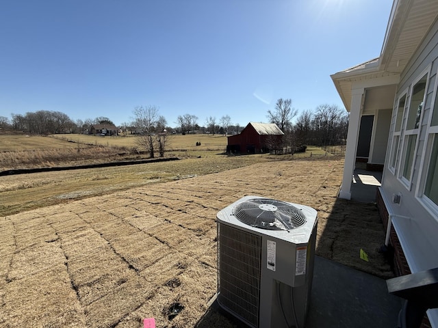 exterior space featuring cooling unit and a rural view