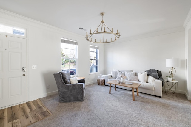 living room featuring wood-type flooring, an inviting chandelier, and ornamental molding