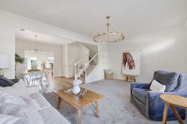 living room featuring light wood-type flooring, an inviting chandelier, and ornamental molding