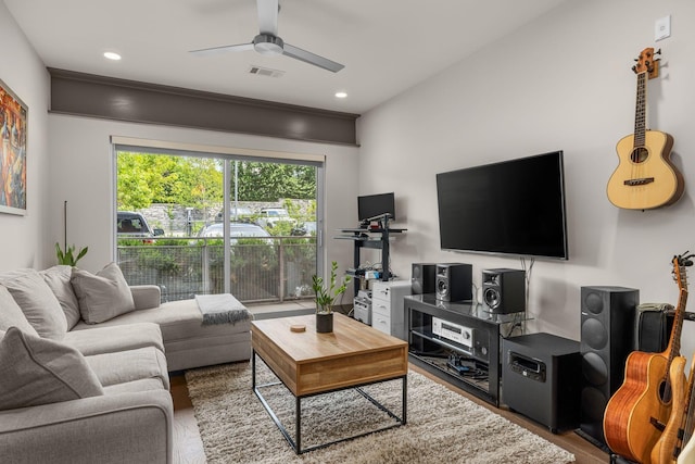 living room with dark hardwood / wood-style flooring and ceiling fan