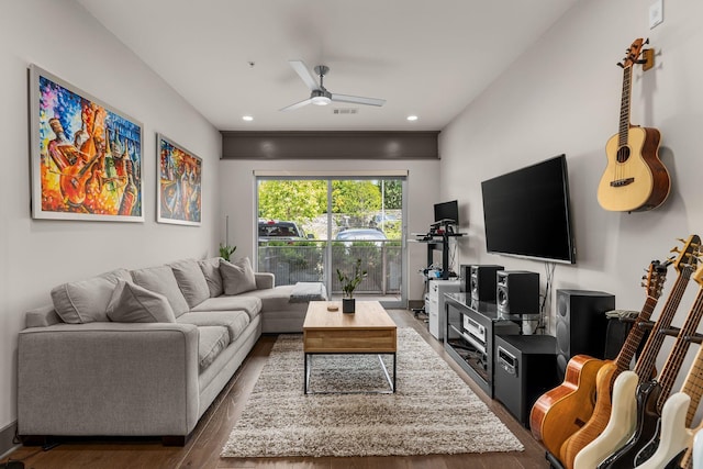 living room with ceiling fan and dark hardwood / wood-style flooring