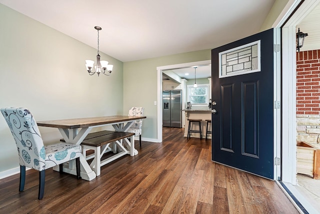 dining room featuring an inviting chandelier and dark wood-type flooring