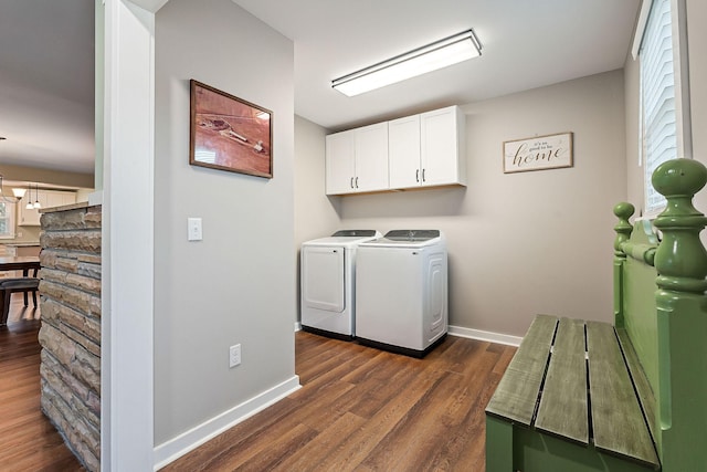 clothes washing area with dark hardwood / wood-style floors, cabinets, and washing machine and clothes dryer