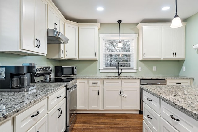 kitchen with white cabinetry, sink, stainless steel appliances, dark hardwood / wood-style flooring, and pendant lighting